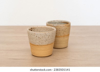 Two coffee cups, various colours, wooden table, home decor, white background, product photography, arts and crafts - Powered by Shutterstock