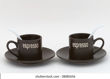 Two coffee cups with white tea-spoons