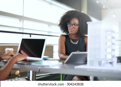 Two  colleages discussing ideas using a tablet computer - Powered by Shutterstock