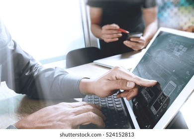 Two Colleague Web Designer Discussing Data And Digital Tablet Docking Keyboard And Computer Laptop With Smart Phone And Design Diagram On Marble Desk,sun Light Effect