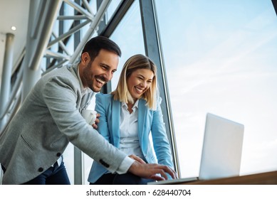 Two colleagues checking internet while having a coffee break. - Shutterstock ID 628440704