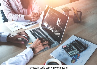 Two Colleagues Discussing Data With  New Modern Computer Laptop On Desk Table. Close Up Business Team Analysis And Strategy Concept.