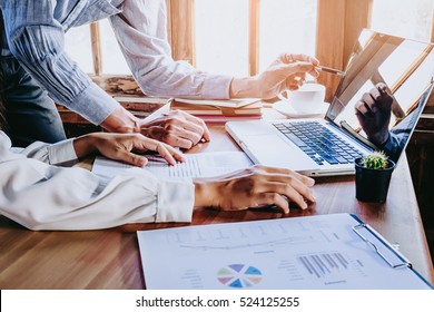 Two colleagues discussing data with new modern computer laptop on desk table. Close up business team analysis and strategy concept. - Shutterstock ID 524125255