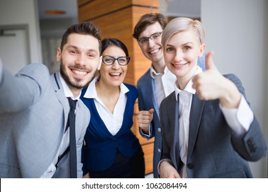 Two Colleagues Do Selfie On A Smartphone In The Office
