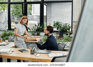 Two colleagues enjoy a casual lunch together in a bright office filled with plants. - Powered by Shutterstock