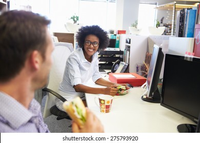 Two Colleagues Having A Lunch Break At Work