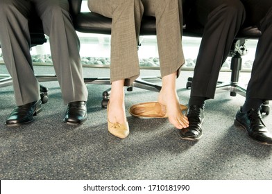 Two Colleagues Playing Footsie Under A Table