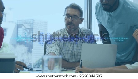 Two colleagues are talking and using a laptop in a modern office. An image of a frequency analyser and sound level peak meter is displayed in blue squares on a black background. This conceptually