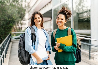 Two College Student female friends smiling ready for classes at the University campus - Powered by Shutterstock