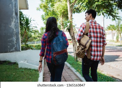 Two College Student Walking To Campus Shoot From Behind