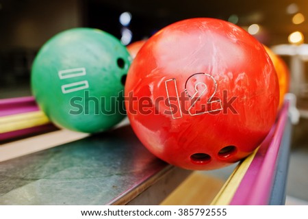 Two colored bowling balls of number 12 and 11