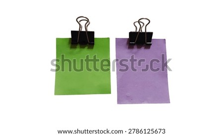 Two colored papers clipped with binder clips