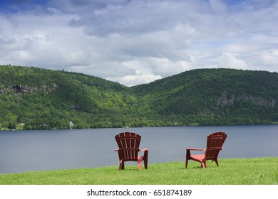Two colorful beach chairs at shore of Lake , Summer, La Mauricie National Park, Quebec, Canada