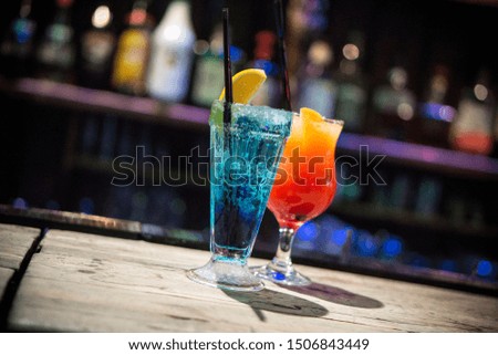 two colorful cocktails on the wood table