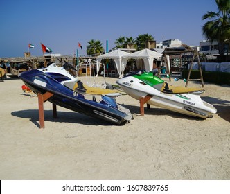 Two Colorful Jet Ski Parked On The Beach Of Holiday Season. Old Jet Skis On The Beach On Wooden Trailer. Blue And White Jet Ski - Dubai Uae January 2020