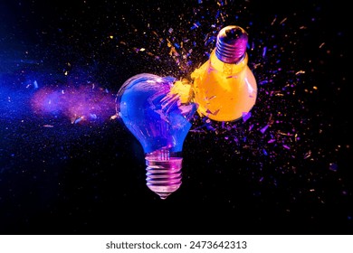 Two colorful light bulbs exploding  black background creativity concept