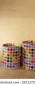 Two colorful polka dot tin cans. 