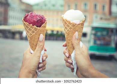 Two Colorful Tasty Ice Cream Cones In Hands