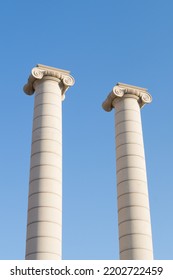 Two columns of the famous "Cuatro Columnas" or "Quatre columnes" of Barcelona (Catalonia, Spain). Two white columns or pillars with the blue sky in the background. - Shutterstock ID 2202722459