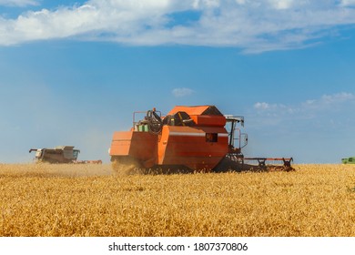Two combines harvests ripe wheat in the grain field. Agricultural work in summer. Detail of the combine close-up. - Shutterstock ID 1807370806