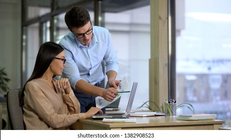 Two company employees preparing report, comparing graphics, business career - Shutterstock ID 1382908523
