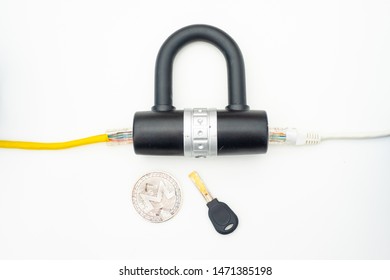 Two computer network cables going through a lock with a key and a crypto currency coin, depicting digital security, cybersecurity or internet security