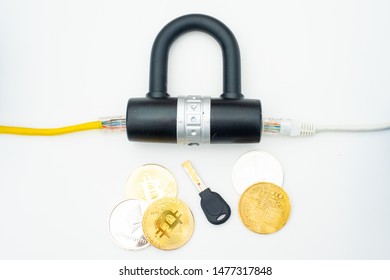 Two computer network cables going through a lock with a key and a crypto currency coin, depicting digital security, cybersecurity or internet security