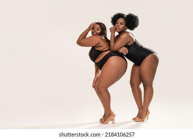 Two Confident, Beautiful Female Models In Black Underwear With Different Body Shape, Posing Together In Studio. Body Positive Concept. Copy Space. 
