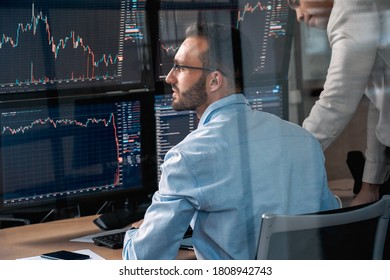 Two Confident Stock Broker Looking At Display, Analyzing Global Bitcoin Price On Network Diagram And Working Together In Office