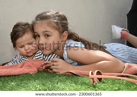 two conniving sisters playing in the grass