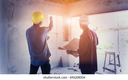 two construction engineers working together in side building planning for the renovation construction site engineer, effect Vintage sun flare. - Shutterstock ID 696208504