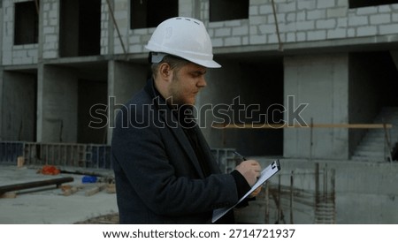 Two construction professionals discussing plans on a working building site