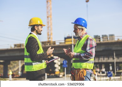 Two Construction Workers Discussing