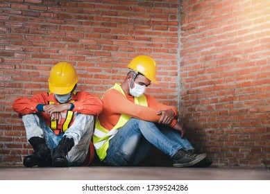 Two Construction Workers Mourning Sad Seats At The Job Site. Wearing A Mask To Prevent Covid-19 Is Unemployment And Economic Crisis. Unemployment Failure During Covid Strain Omicron , Delta