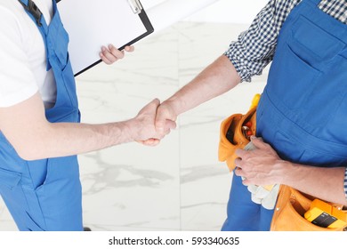 Two construction workers shaking hands, deal is finished concept - Powered by Shutterstock - Get 15% off with code: PIKWIZARD15
