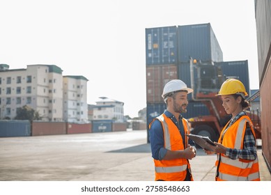 Two construction workers using tablet and clipboard at shipping container siteKeywords (45):