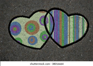 Two cookie cutter hearts in the sand with pattern overlay - Powered by Shutterstock