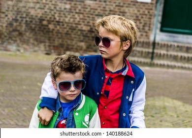 Two Cool Kids With Sunglasses Looking Tough