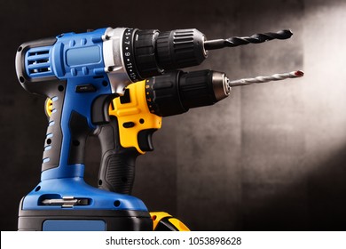 Two cordless drills with drill bits working also as screw guns.