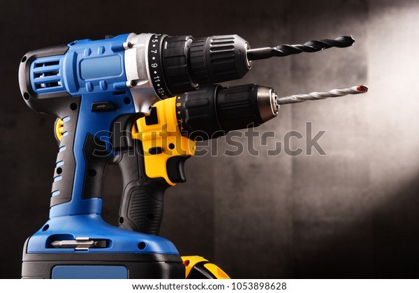 Two cordless drills with drill bits working also as\
screw guns.