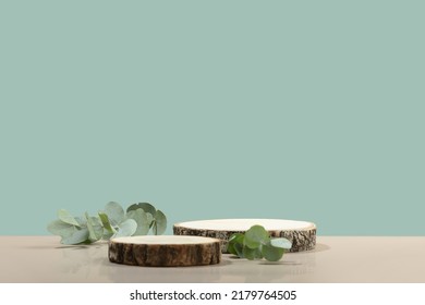 Two cosmetic product podiums mockup. Background for presentation of cosmetic. Minimal modern product display on neutral blue background. Wood slice podium and green leaves. Concept scene - Shutterstock ID 2179764505