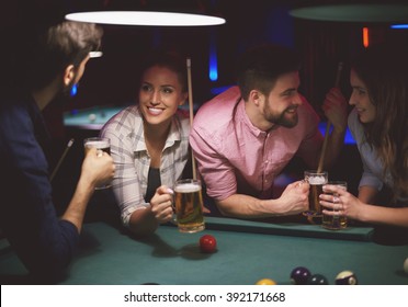 Two Couples Playing Pool Game