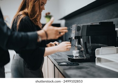 Two coworkers are seen having a relaxing conversation while making coffee in a stylish office kitchen, illustrating a typical office break. - Powered by Shutterstock