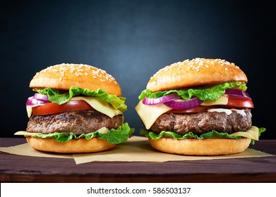 Two craft beef burgers on wooden table isolated on black  background. - Powered by Shutterstock