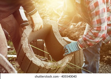 Two Craftsmen Taking Together A Heavy Stone Element