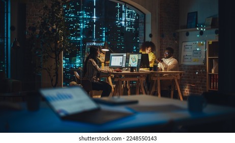 Two Creative Multicultural Colleagues Collaborate on a Project and Work Together as a Team. Marketing Manager and Designer Talking and Discussing Changes to an Advertising Campaign. Evening at Work. - Powered by Shutterstock