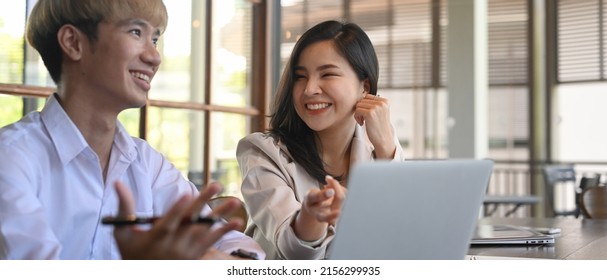 Two Creative People Sharing Ideas, Discussing Discussing Information Online At Modern Office.