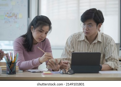 Two Creative People Working On New Project Together At Office.