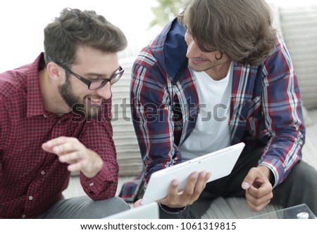 two creative web designers working with a tablet and a laptop.