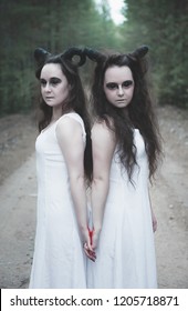 Two Creepy Twins Demons With Horns In Forest Outdoor